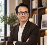 Sung Won, MD in a brown jacket with arms crossed