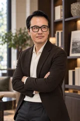 Sung Won, MD standing in a brown jacket in an office